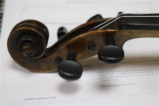 A cased violin bearing Cremoneous label and two bows